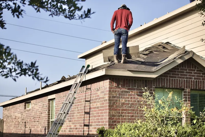 Professional roofer working on a residential roof in Gwynn Oak